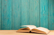 © Sensay - Open book on the desk over wooden background