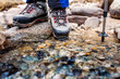 © EdNurg - young woman traveling in mountains, wading rocky river