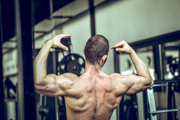 Wall Mural - Man showing back in gym