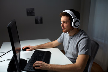 Wall Mural - man in headset playing computer video game at home