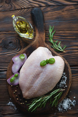 Poster - Above view of fresh uncooked whole chicken breast and condiments