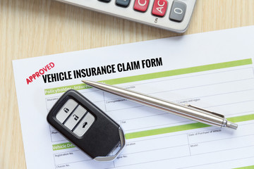 Wall Mural - Top view of Approved vehicle insurance claim form with car key