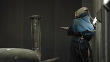 Worker Sandblasting Gas Pipe