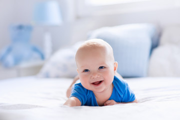 Wall Mural - Baby boy in white sunny bedroom