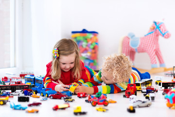 Wall Mural - Little kids playing with toy cars