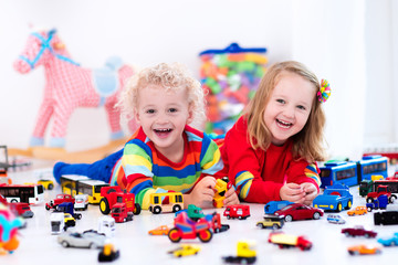 Wall Mural - Little kids playing with toy cars