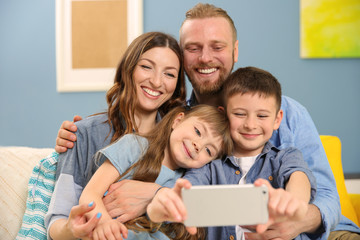 Poster - Happy family taking selfie on blue wall background