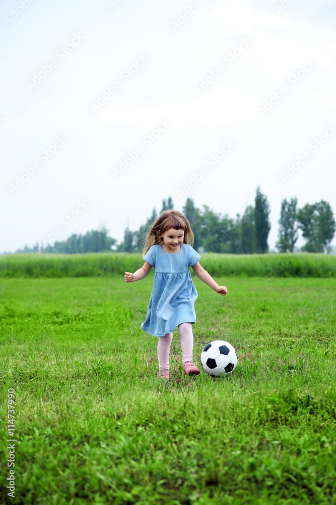 Little girl playing football outdoor Stock Photo | Adobe Stock
