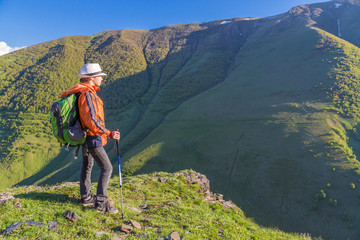 Girl traveling on mountains with backpack