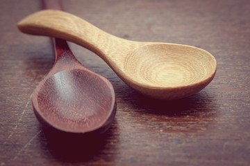 Wooden spoon on wood table with filter effect retro vintage styl