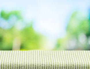 Sticker - Empty green stripes tablecloth with sun and blur green tree boke