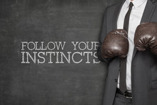 Follow Your Instincts On Blackboard With Businessman On Side