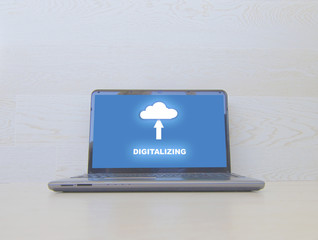 Poster - Laptop with  digitalizing concept on the screen and wooden background.