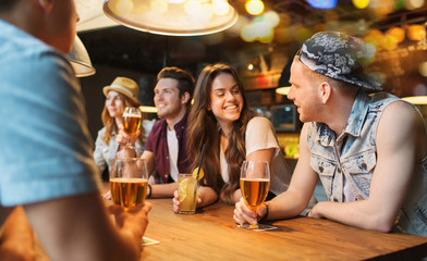 Poster - happy friends with drinks talking at bar or pub