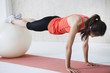 © Monet - Young women are the push-ups with a balance ball