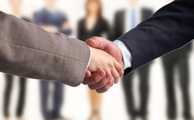 Business handshake. Two businessman shaking hands with each other in the office