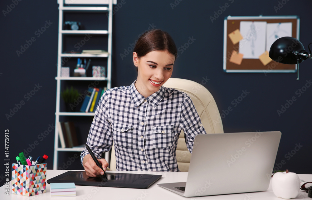 Woman using graphic tablet at office