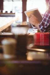 Poster - Mid section of waiter using digital tablet