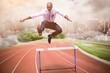 Composite image of businessman jumping a hurdle