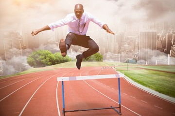 Poster - composite image of businessman jumping a hurdle