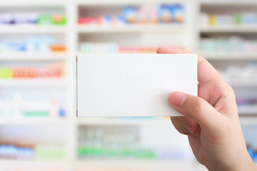 Wall Mural - Close up pharmacist hand hold medicine box package