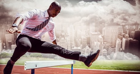 Poster - Composite image of businessman jumping a hurdle