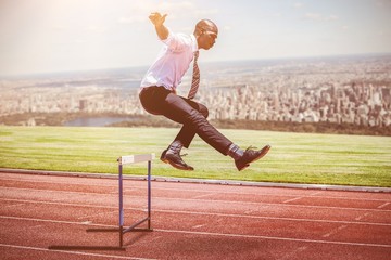 Poster - composite image of businessman jumping a hurdle