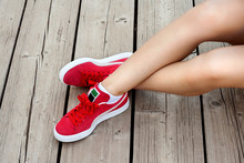 Shapely Woman Legs In Red Sneakers