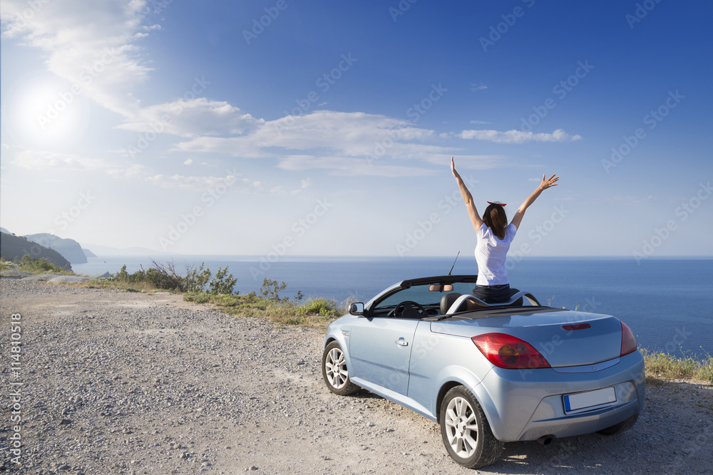 Young woman drive a car on the beach. - obrazy, fototapety, plakaty 