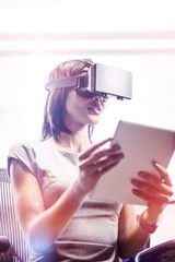 Poster - Businesswoman looking her tablet while using a virtual glasses