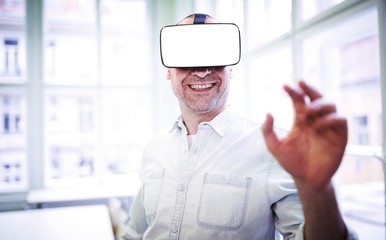 Poster - Smiling graphic designer using virtual reality headset 