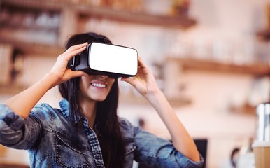 Poster - Young woman using the virtual reality headset