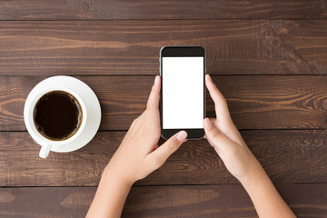 Canvas Print - phone white screen in woman hand on table top view