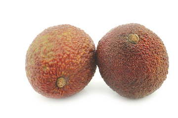 two fresh eat ripe avocado's on a white background