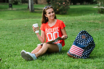 Happy female tourist relaxing in park