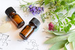 essential oils with herbs on science sheet