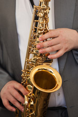 Poster - Saxophone musician in his hands closeup