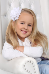 Portrait of a cute little blond girl with long hair