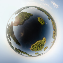 Little planet of islands at a lake