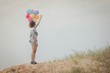 © Johnstocker - young beautiful woman holding balloon very happy on the fresh ai