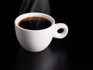 White Cup of hot black coffee on table with black background