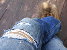 Men In Torn Jeans Closeup