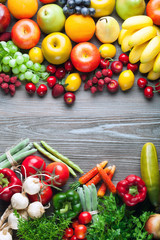 Mixed fruits and vegetables on wooden board, concept of healthy eating and diet