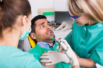 Dentist and scared patient .