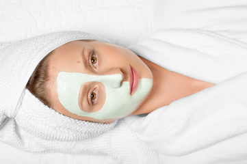 Wall Mural - Beauty Treatments. Woman applying facial mask at spa