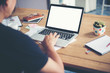 © Johnstocker - man hands typing working with laptop on wooden desk.