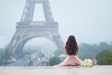 Parisian Woman In Front Of The Eiffel Tower