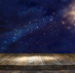 Image of wooden table in front of glitter lights background