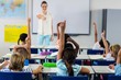 © WavebreakMediaMicro - Teacher pointing students with raised hands