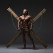 © kazanovskyiphoto - Sexual naked man, muscular, hands tied rope to wooden beams